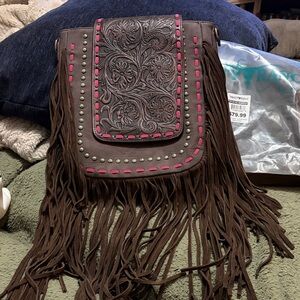 Trinity Ranch brown tooled bag with fringe and pink accents. It’s also a CC.